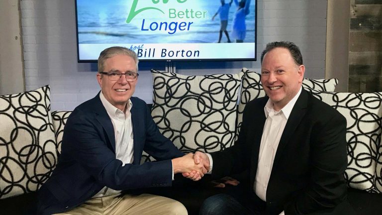 Bill Borton and Rob Blatt shaking hands during an interview