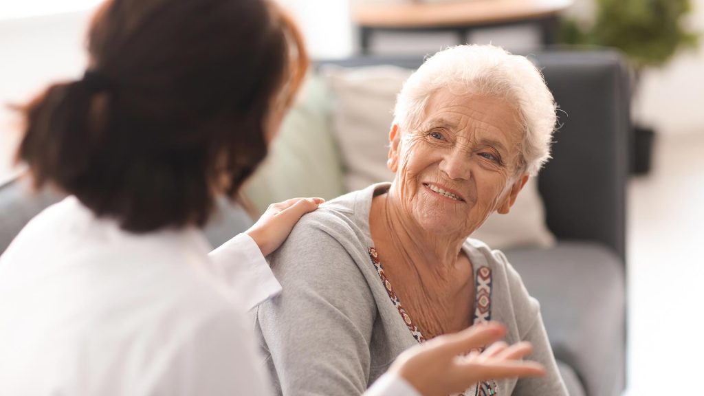 Senior woman sitting with her health care aide